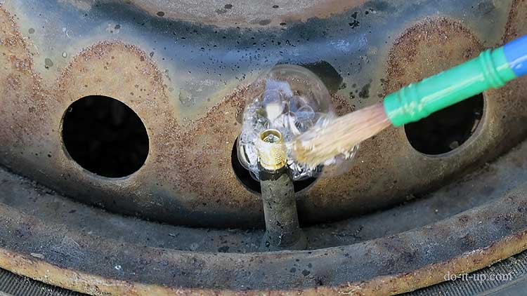 Testing a Tyre Valve With Soapy Water