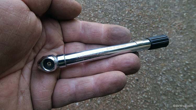 A Wheel Valve Removal Tool on the end of a Pressure Gauge